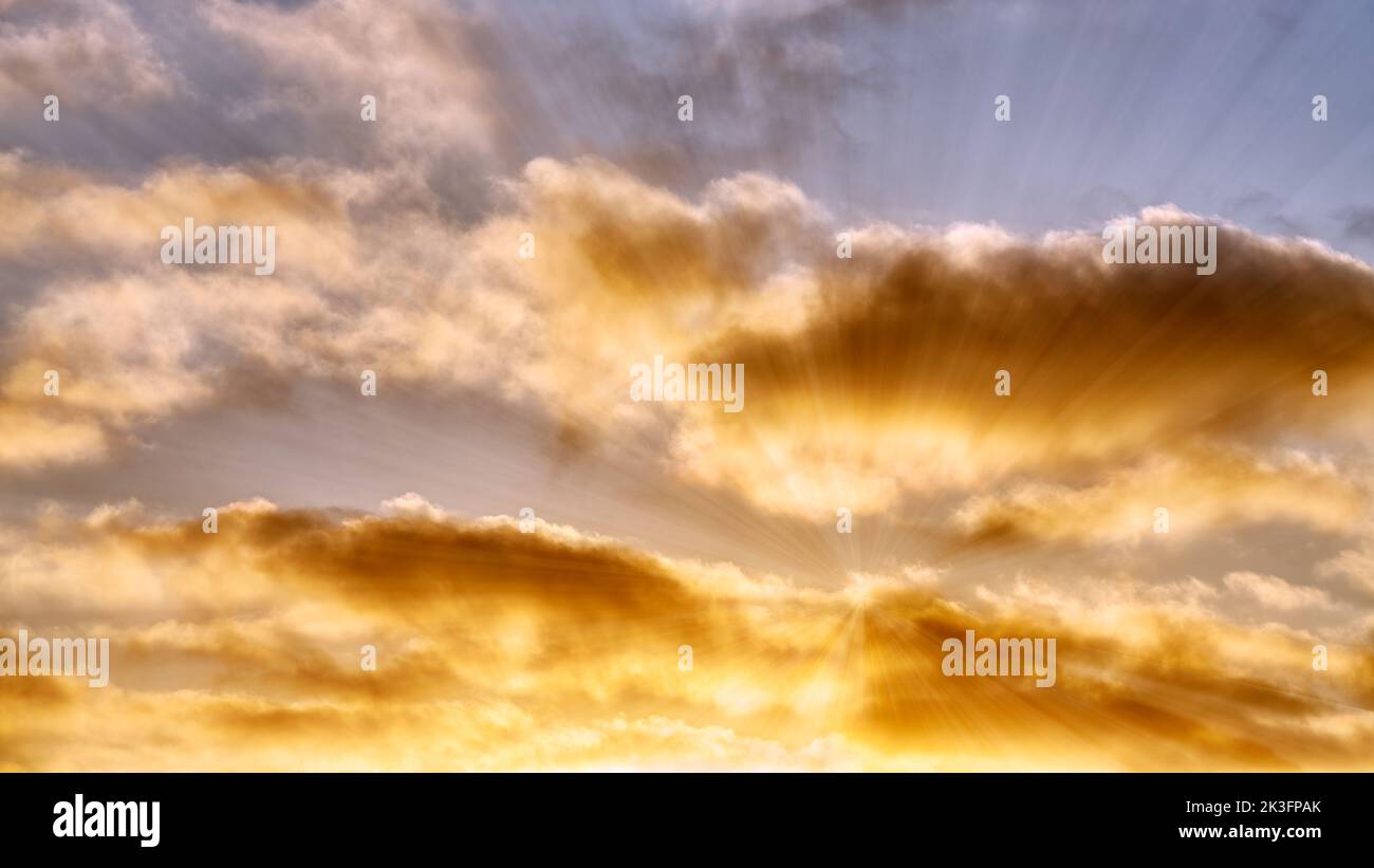 A Detailed Image Of White Clouds With Bright Sun Rays Emanating Stock Photo