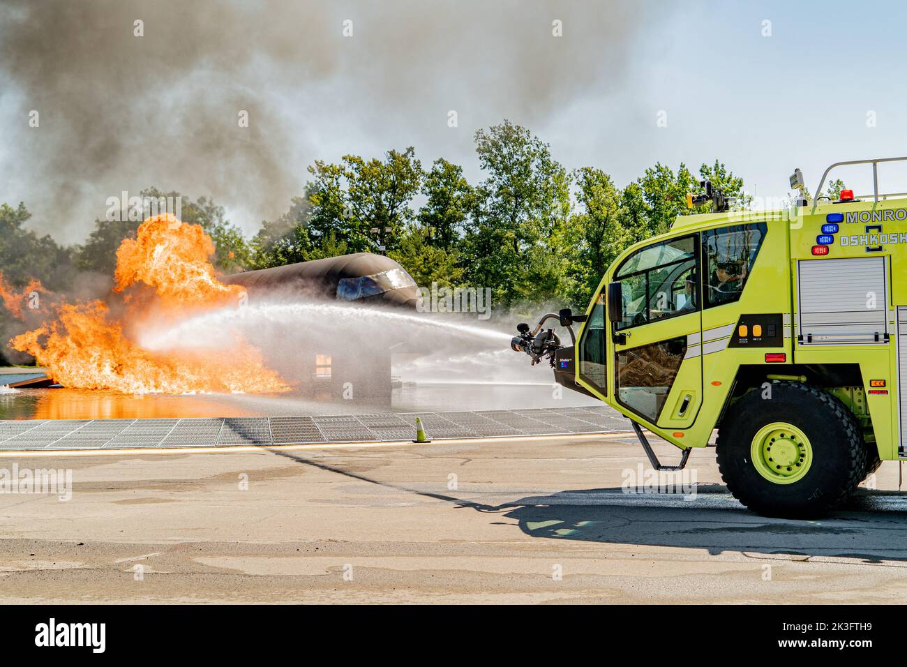 Firefighters with the 914th Fire Emergency Services work to put out the flames of a simulated Boeing 737 crash at a training facility in Rochester, New York, August 24, 2022.  Training for an aircraft fire enhances readiness of our firefighters by giving them hands on experience on how to suppress and ultimately put out the flames as quickly as possible to prevent further damage or injuries. (U.S. Air Force Photo by Airman Kylar Vermeulen) Stock Photo