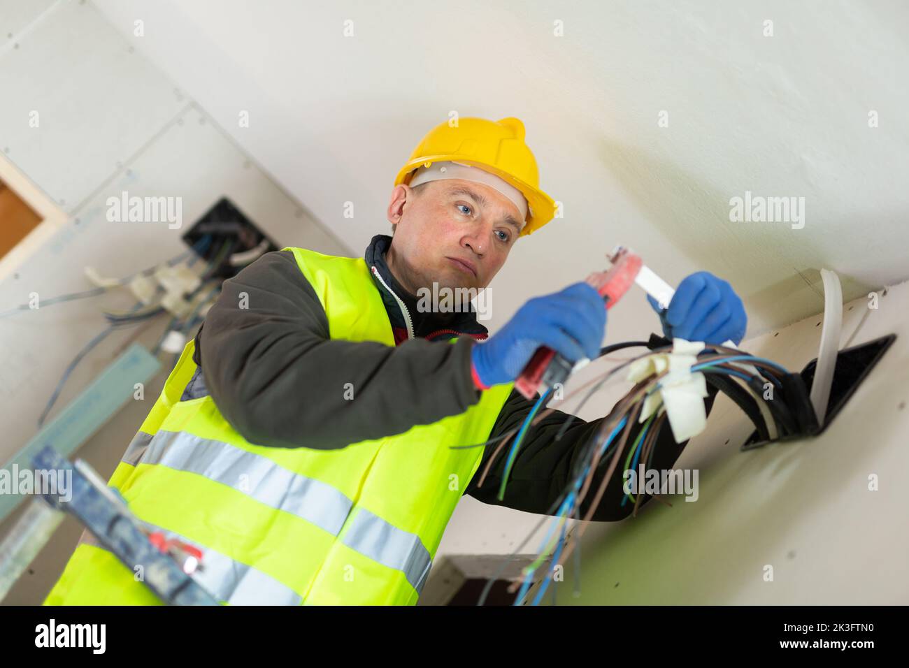 Electrician installing electricity in new house Stock Photo Alamy