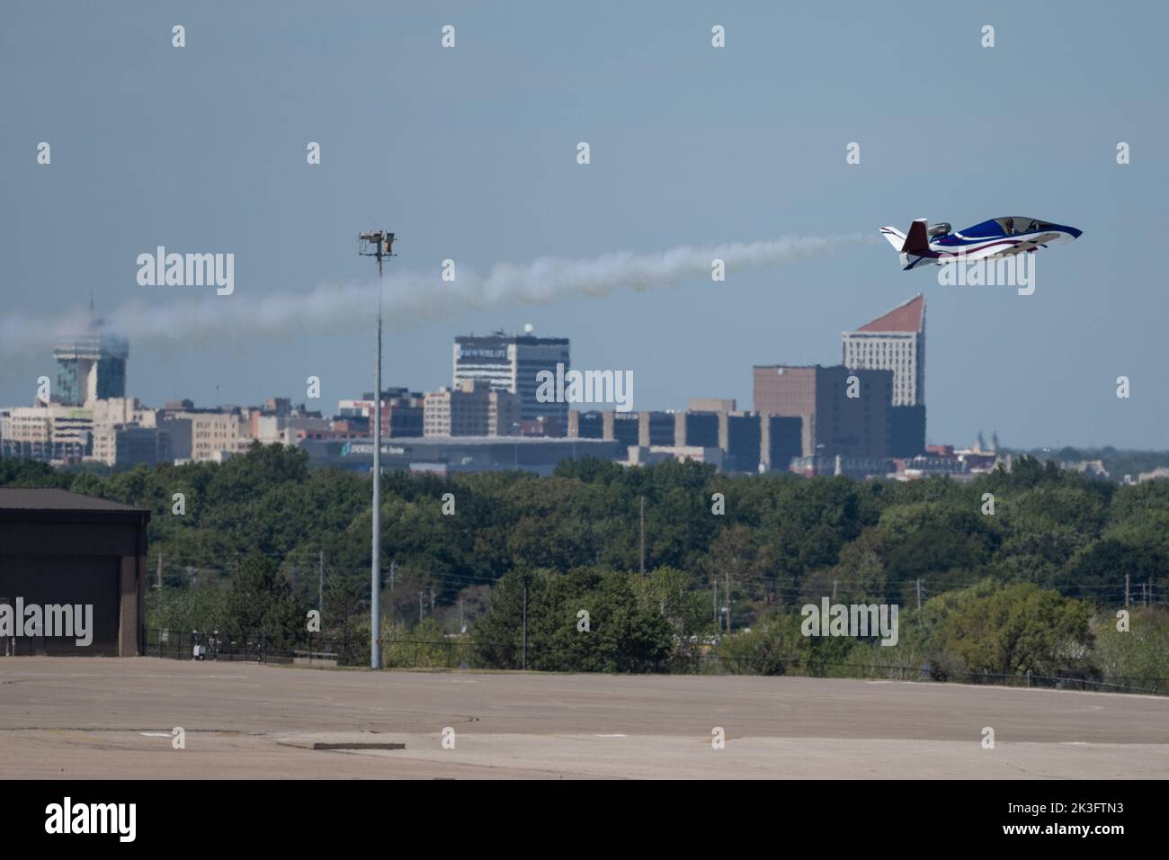 Tom Larkin with Mini Jet Airshows flys by the Wichita skyline during