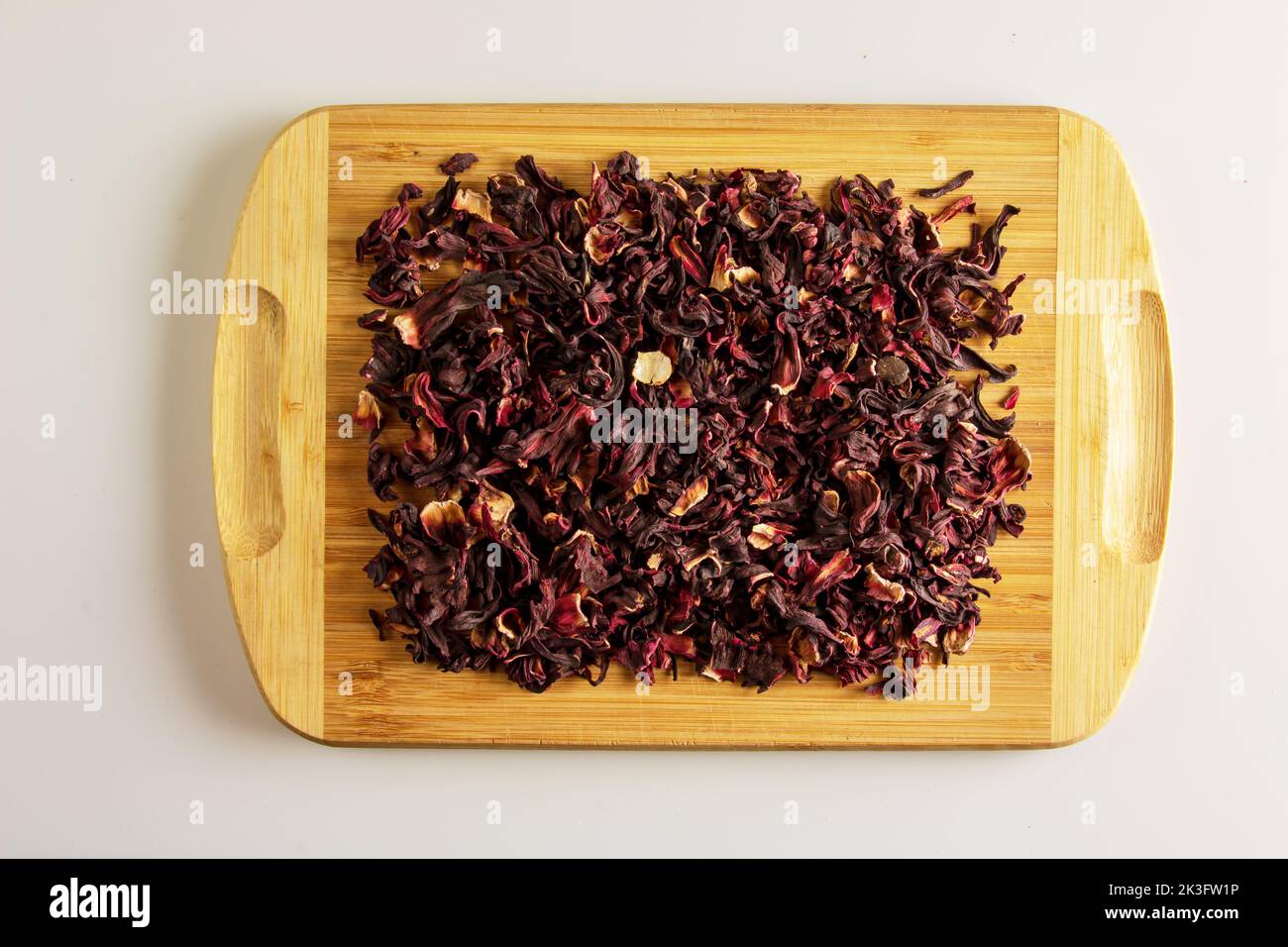 Tea made from dried pomegranate flowers. Increases immunity. Background of fragrant tea on a wooden board. Stock Photo