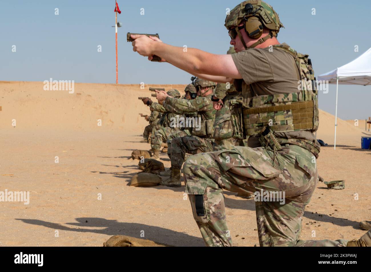 U.S. Air Force Airman 1st Class Wilson Steward, a fireteam member assigned to the 378th Expeditionary Security Forces Squadron, and U.S. Soldiers with Task Force Americal from the 1st Battalion, 182nd Infantry Regiment, conduct live fire pistol training, Sept. 22, 2022, at Prince Sultan Air Base, Kingdom of Saudi Arabia. The U.S. Air Force’s 378th Expeditionary Security Forces Squadron facilitate and occasionally conduct Joint Force training with the U.S. Army on PSAB’s firing range. Soldiers and Airmen must undergo routine weapons qualification training to ensure safety and proficiency standa Stock Photo