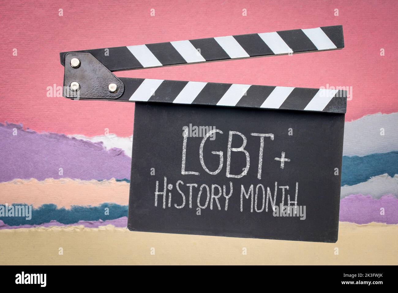 LGBT History Month, white chalk handwriting on a clapboard against abstract paper landscape, reminder of annual monthly event Stock Photo