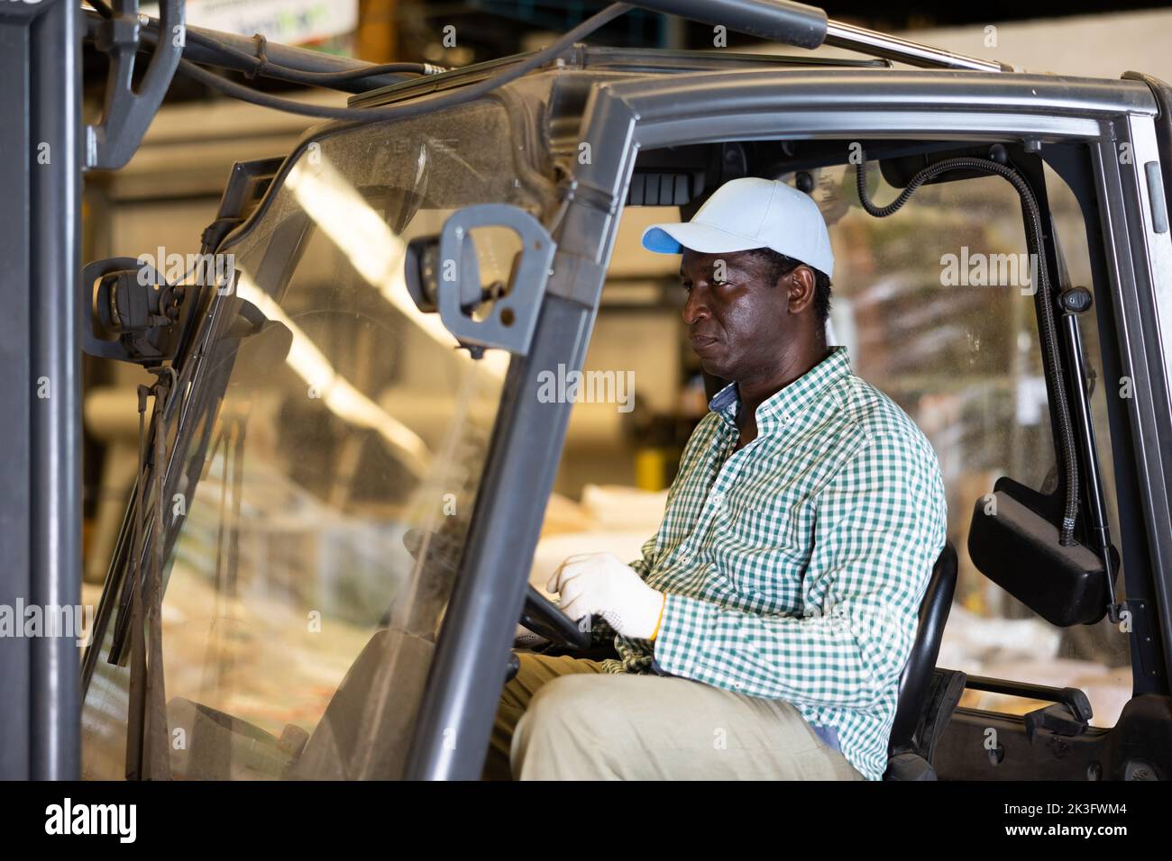 African American worker of warehouse working on forklift truck Stock ...