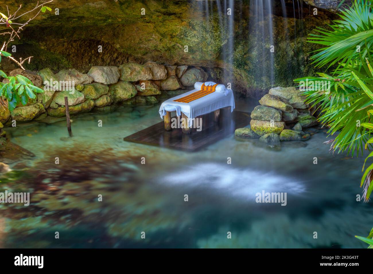 Massage Booth bed in a peaceful corner with lake and waterfall, Cancun