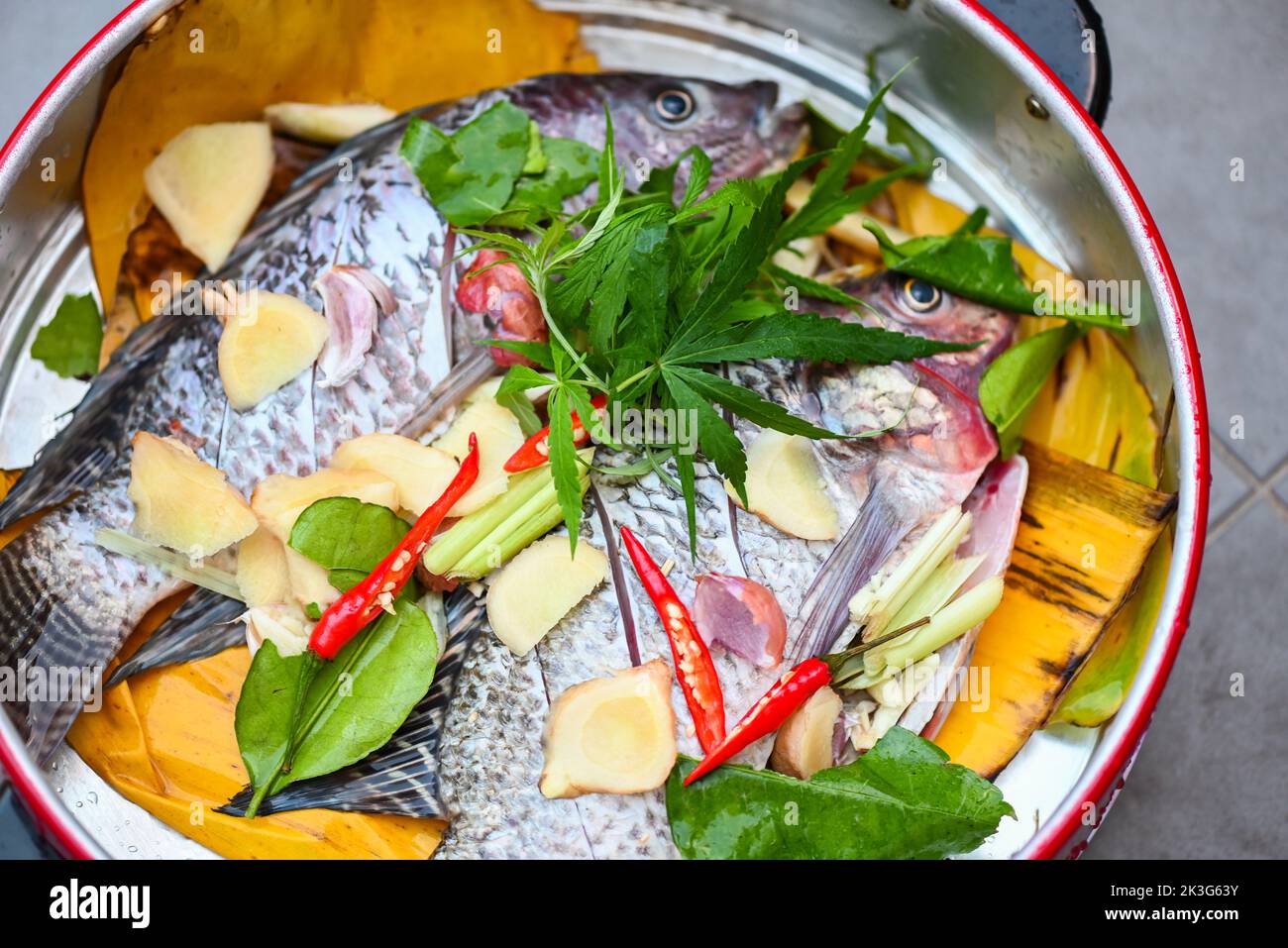 cooking tilapia with herb spice cannabis leaf ginger garlic pepper
