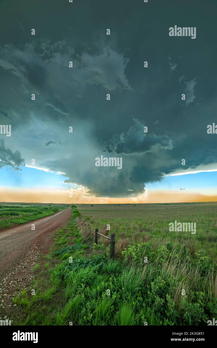 The formation of a mesocyclone is a prelude to a tornado, forming off of a dirt road and a remote area on Oklahoma. Stock Photo