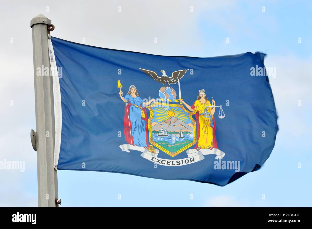 Flag of New York State in blue sky background in village of Waddington, Town of Waddington, Upstate New York NY, USA. Stock Photo