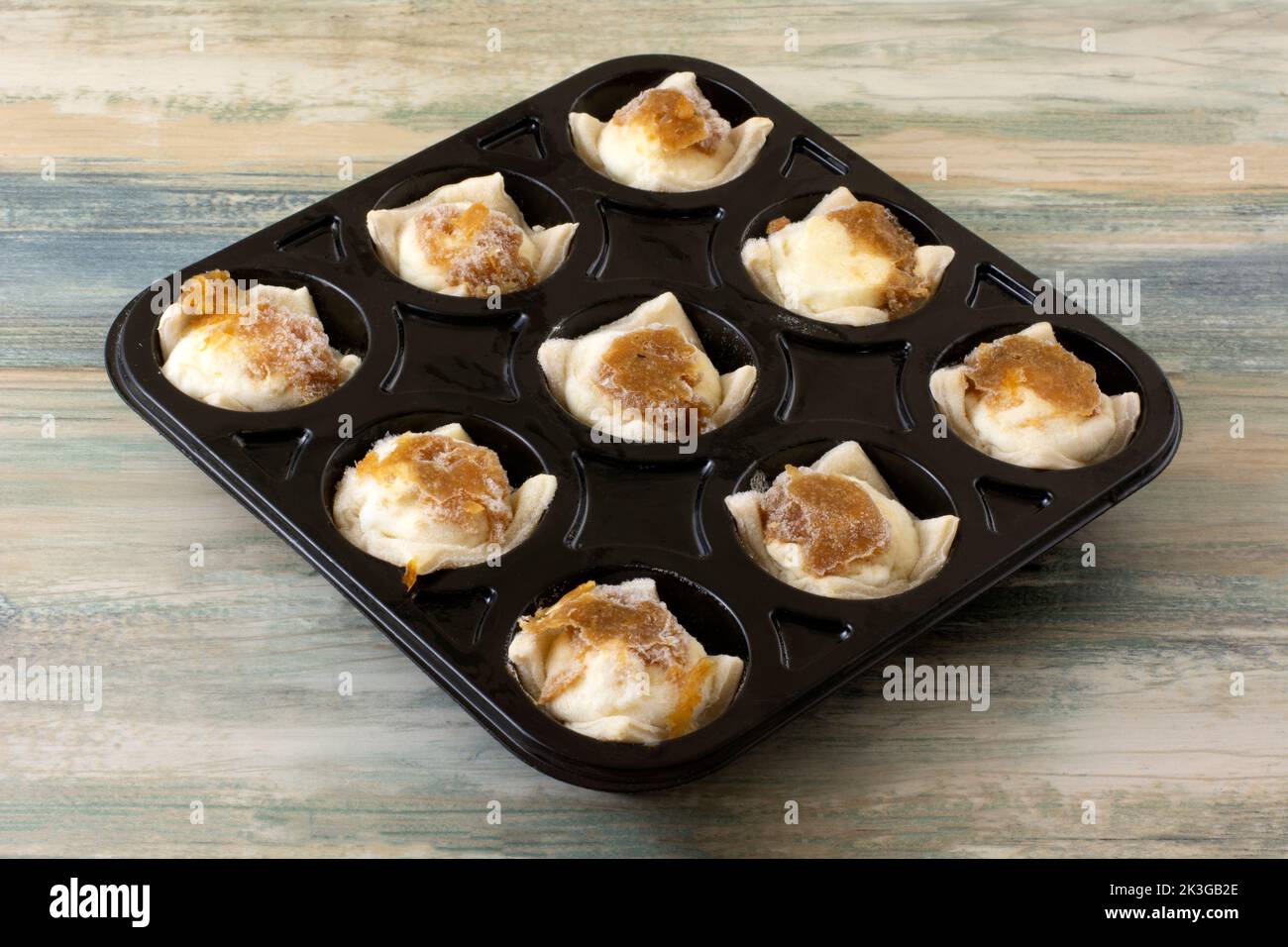 Frozen caramelized onion and feta and cream cheese appetizers in black