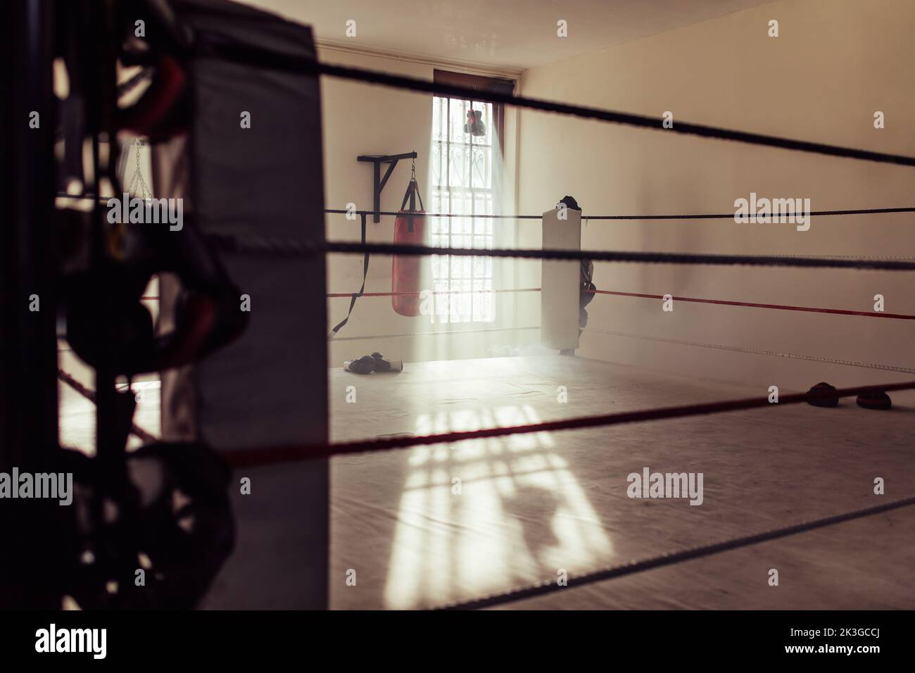 Empty boxing ring as seen from one corner of a boxing ring. Still life shot of a boxing gym during the day. Stock Photo