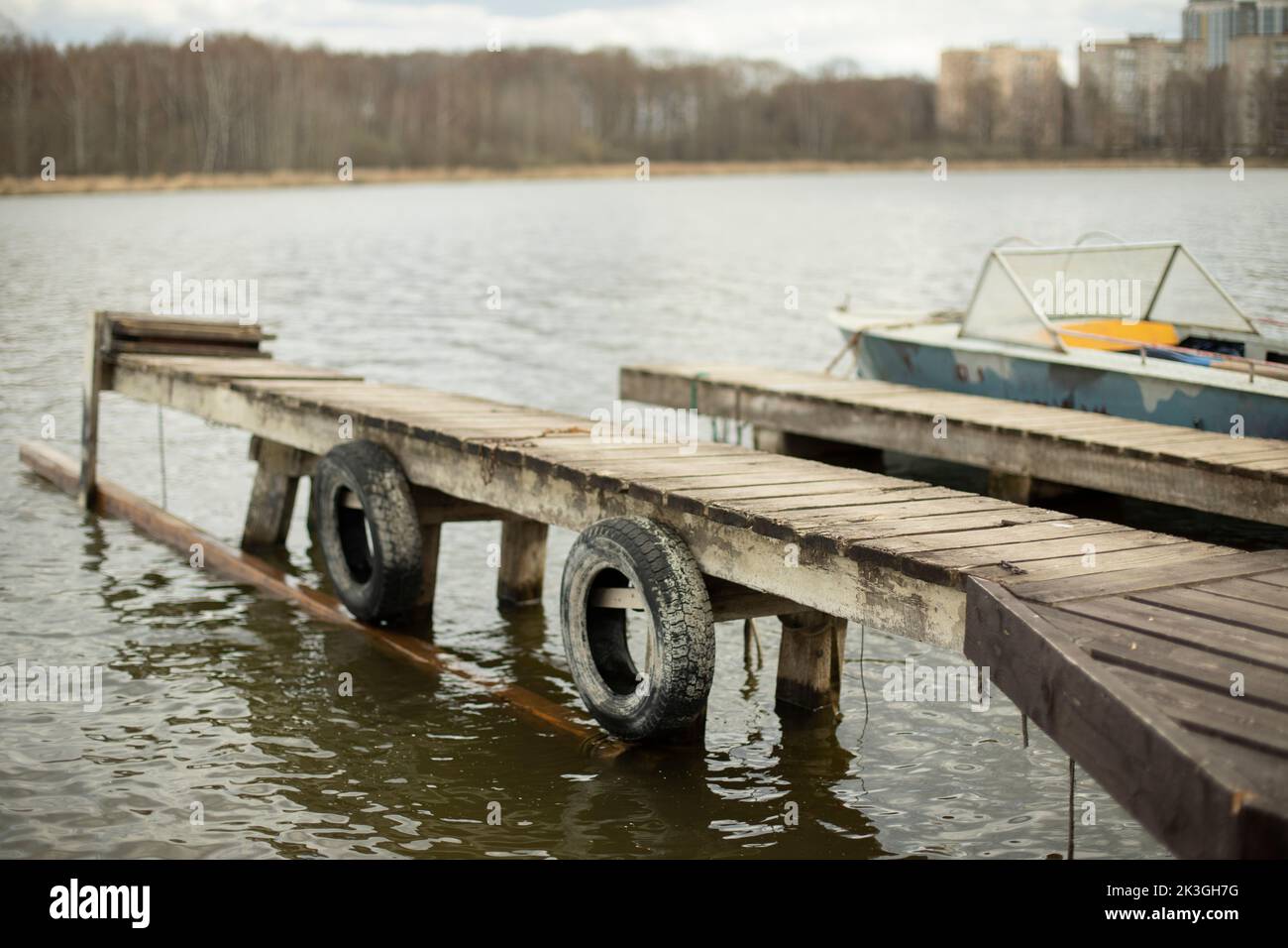 Mooring on lake. Bridge on pond. Wooden pier for mooring boats. Stock Photo