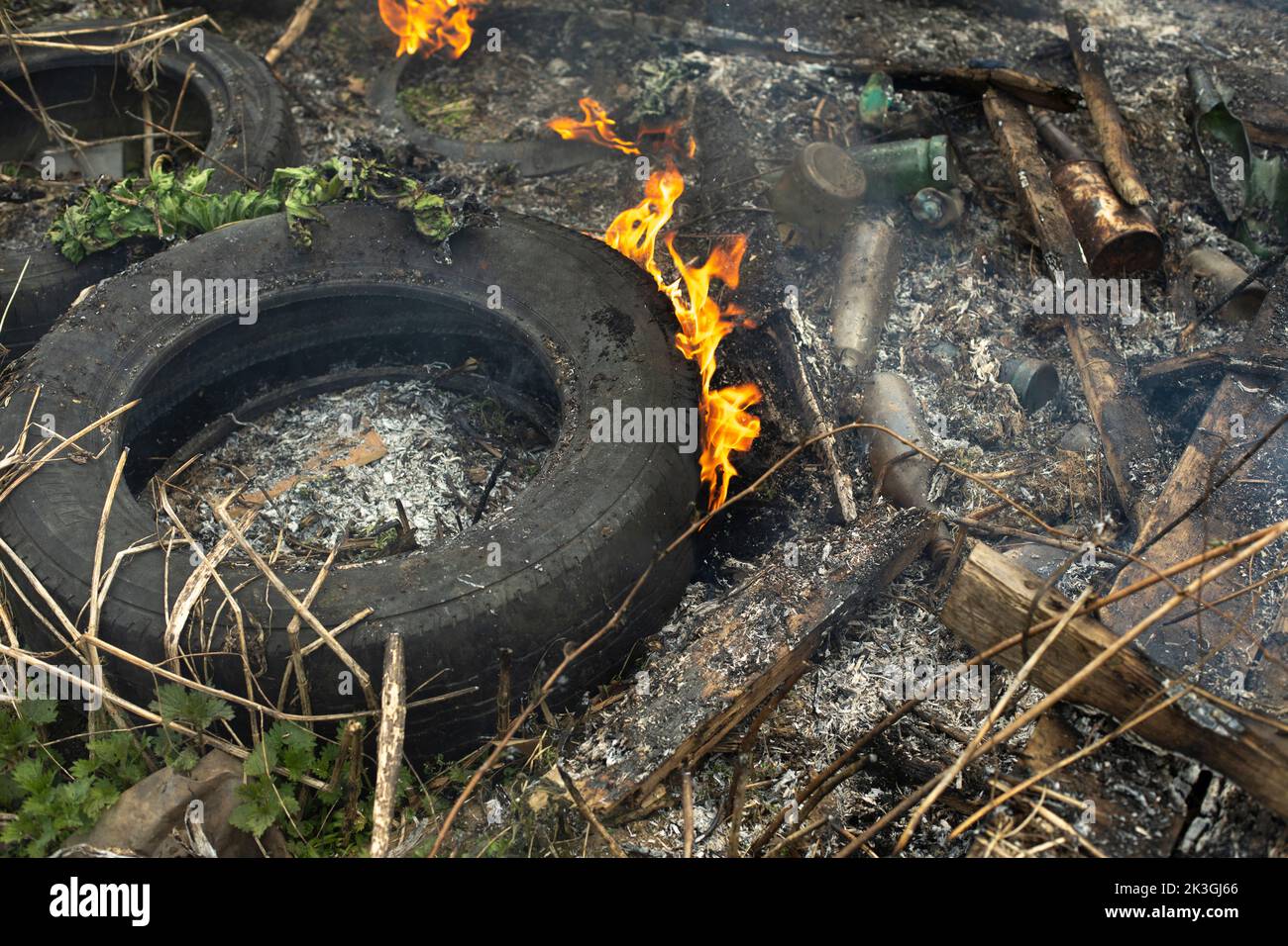 Burning of garbage. Set fire to illegal landfill. Flames and smoke. Environmental disaster Stock