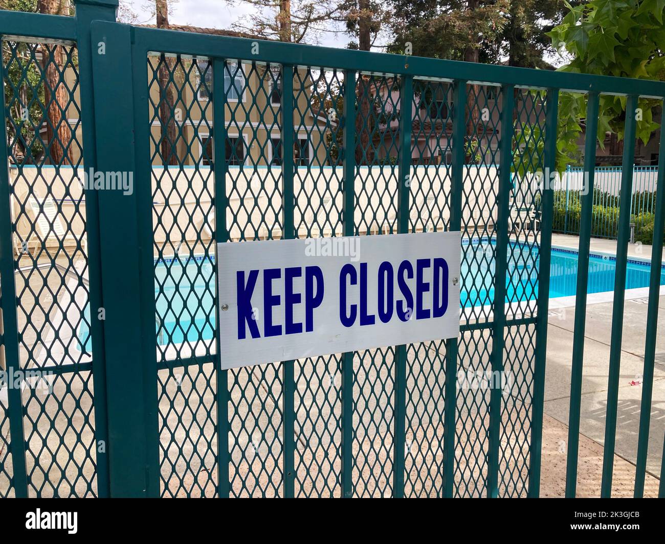 Keep Closed warning sign on the entrance gate to the outdoor pool to