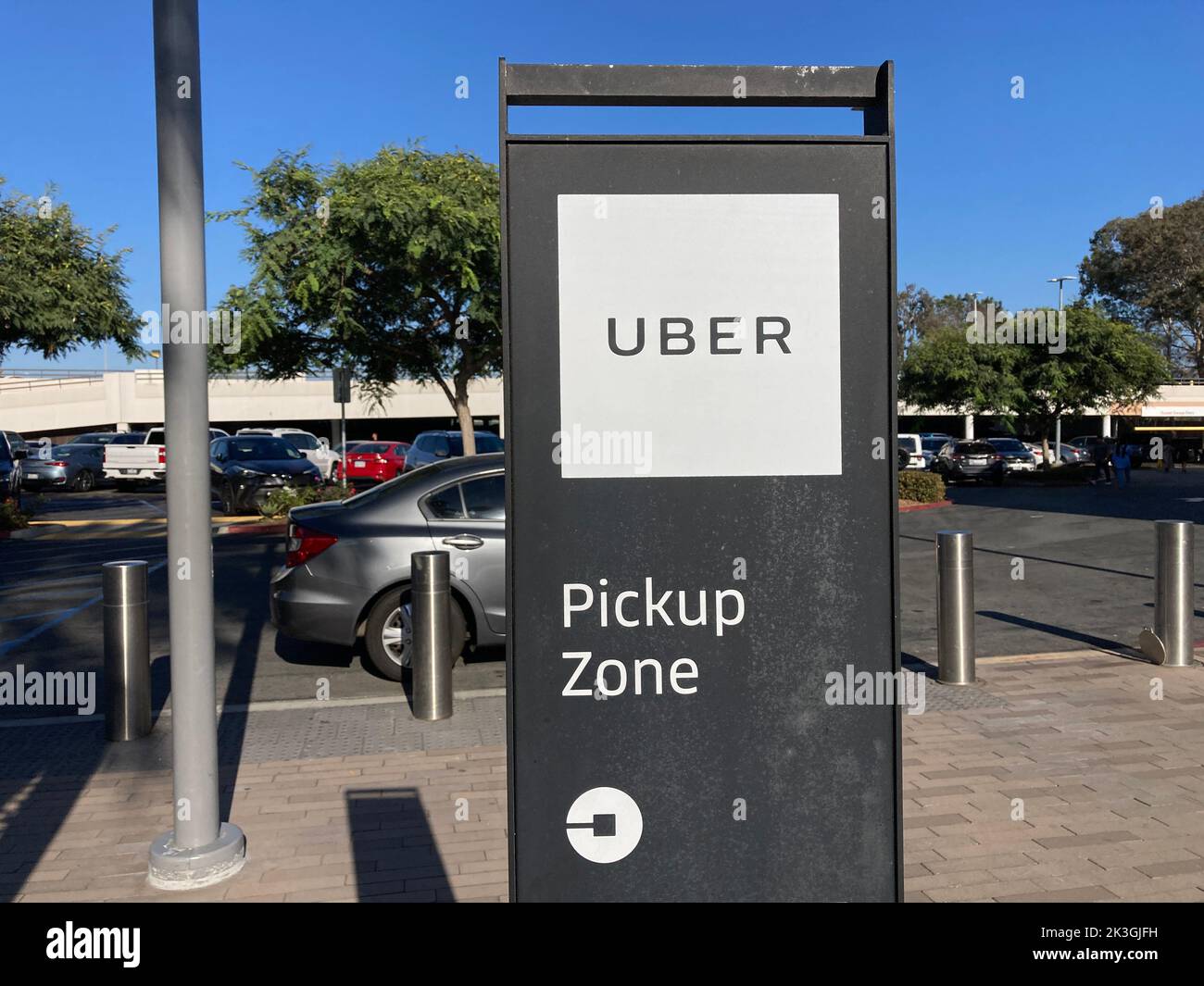 Uber rideshare pickup sign at designated area of shopping center San