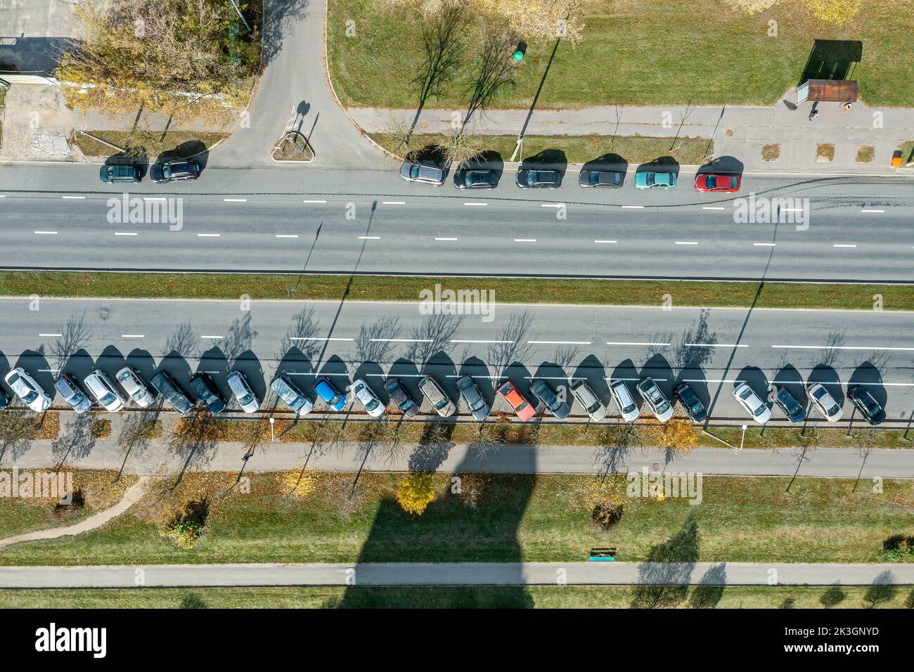 aerial top down view of parked cars on empty urban road on sunny autumn day Stock Photo
