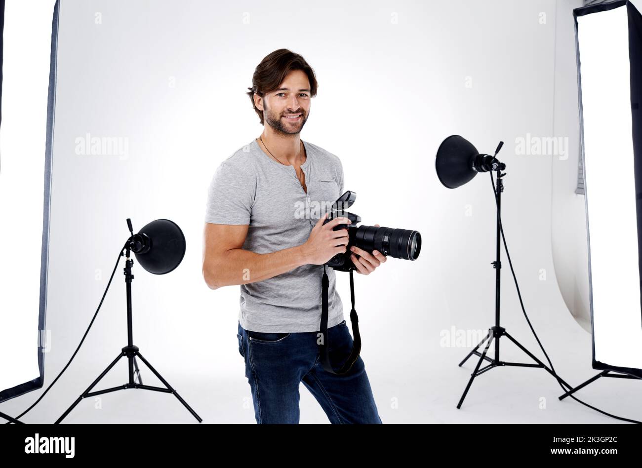 Read..,Aim...Shoot. A professional photographer in his studio. Stock Photo