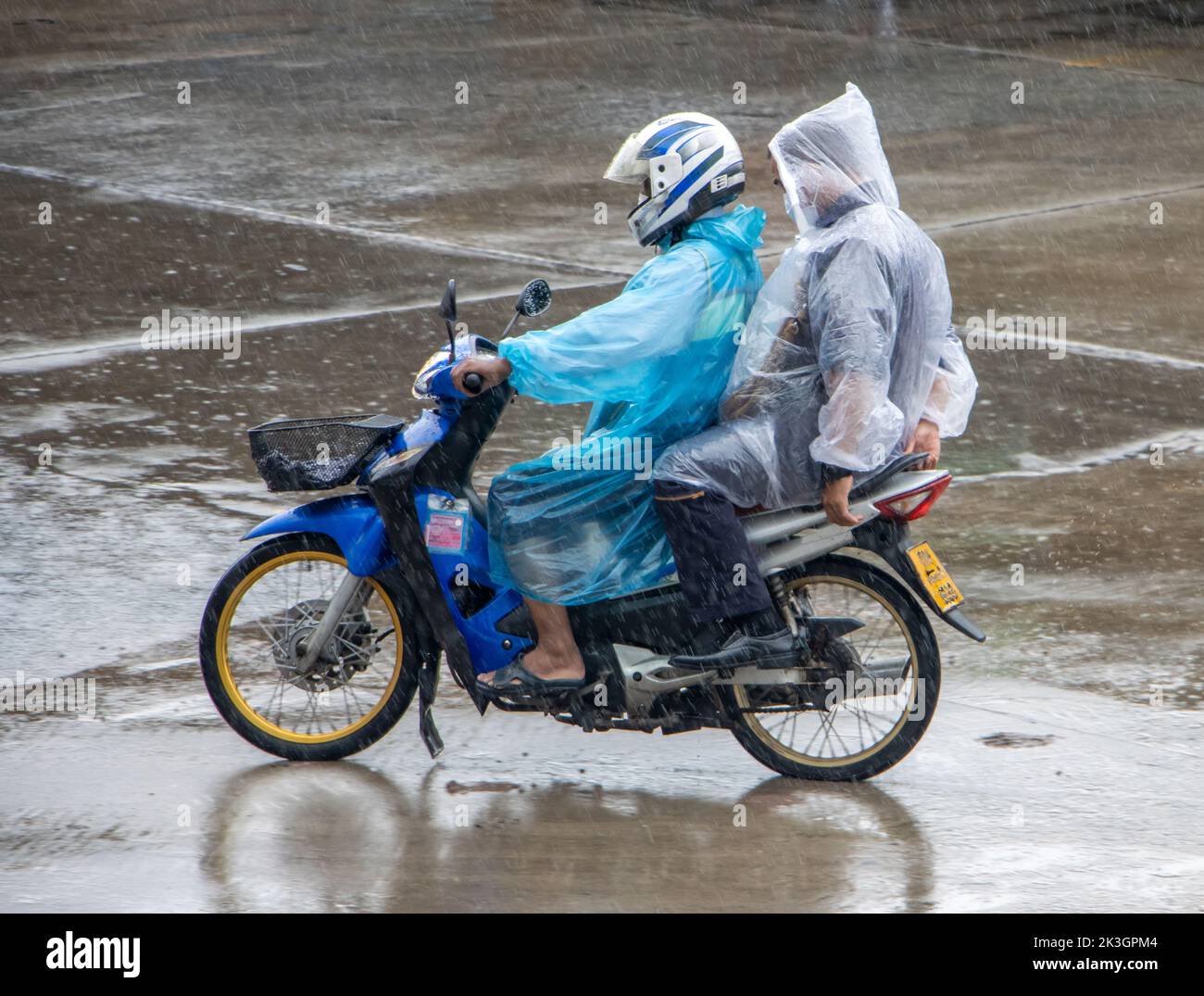 Mototaxi is driving with a passenger in heavy rain Stock Photo