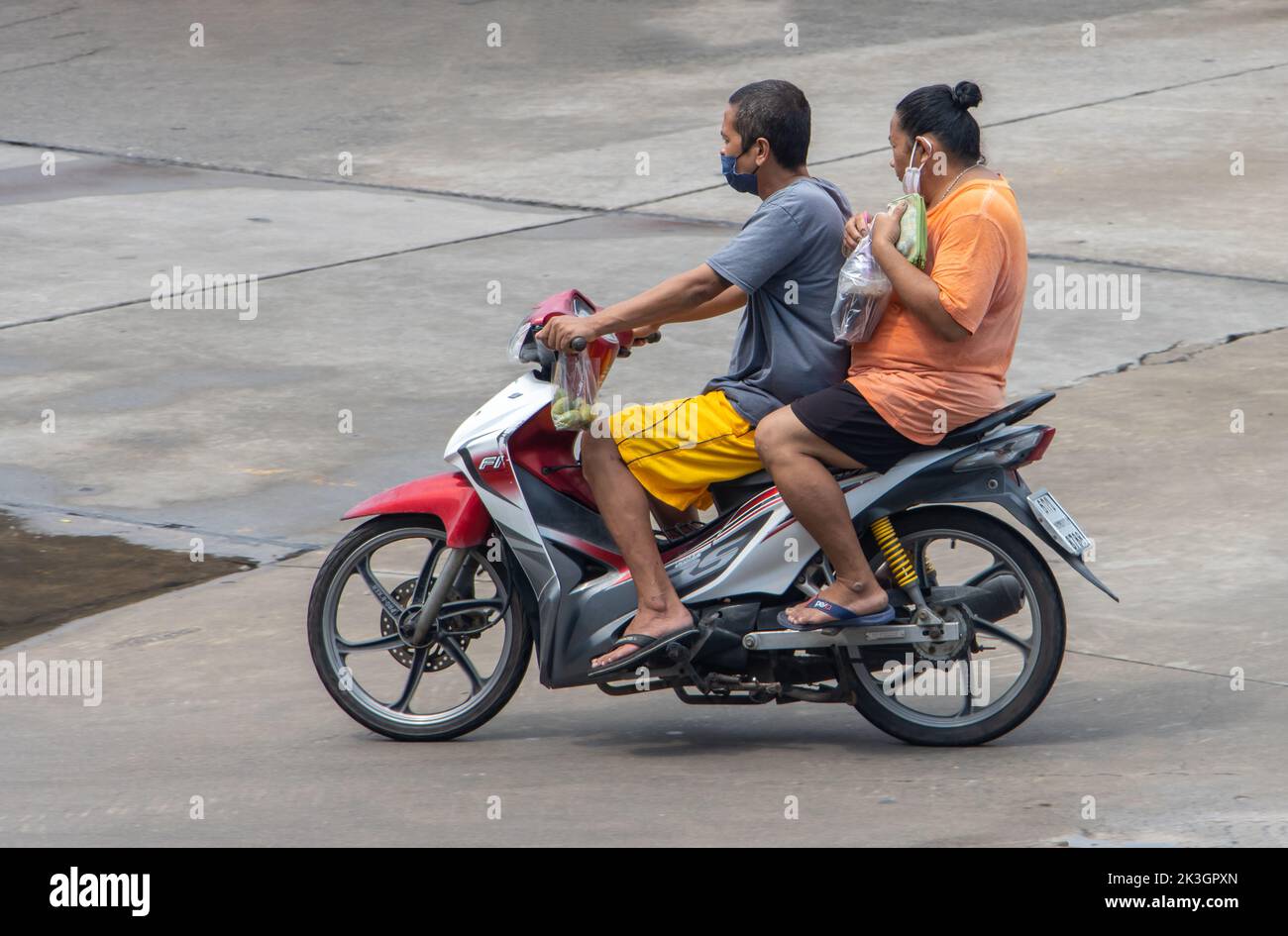 SAMUT PRAKAN, THAILAND, SEP 23 2022,  The pair rides on motorcycle at the street. Stock Photo
