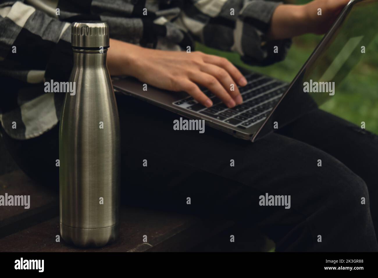 https://c8.alamy.com/comp/2K3GR88/water-bottle-reusable-steel-thermo-water-bottle-on-wooden-bench-sustainable-lifestyle-plastic-free-zero-waste-free-living-go-green-environment-protection-woman-student-work-study-with-laptop-in-park-2K3GR88.jpg