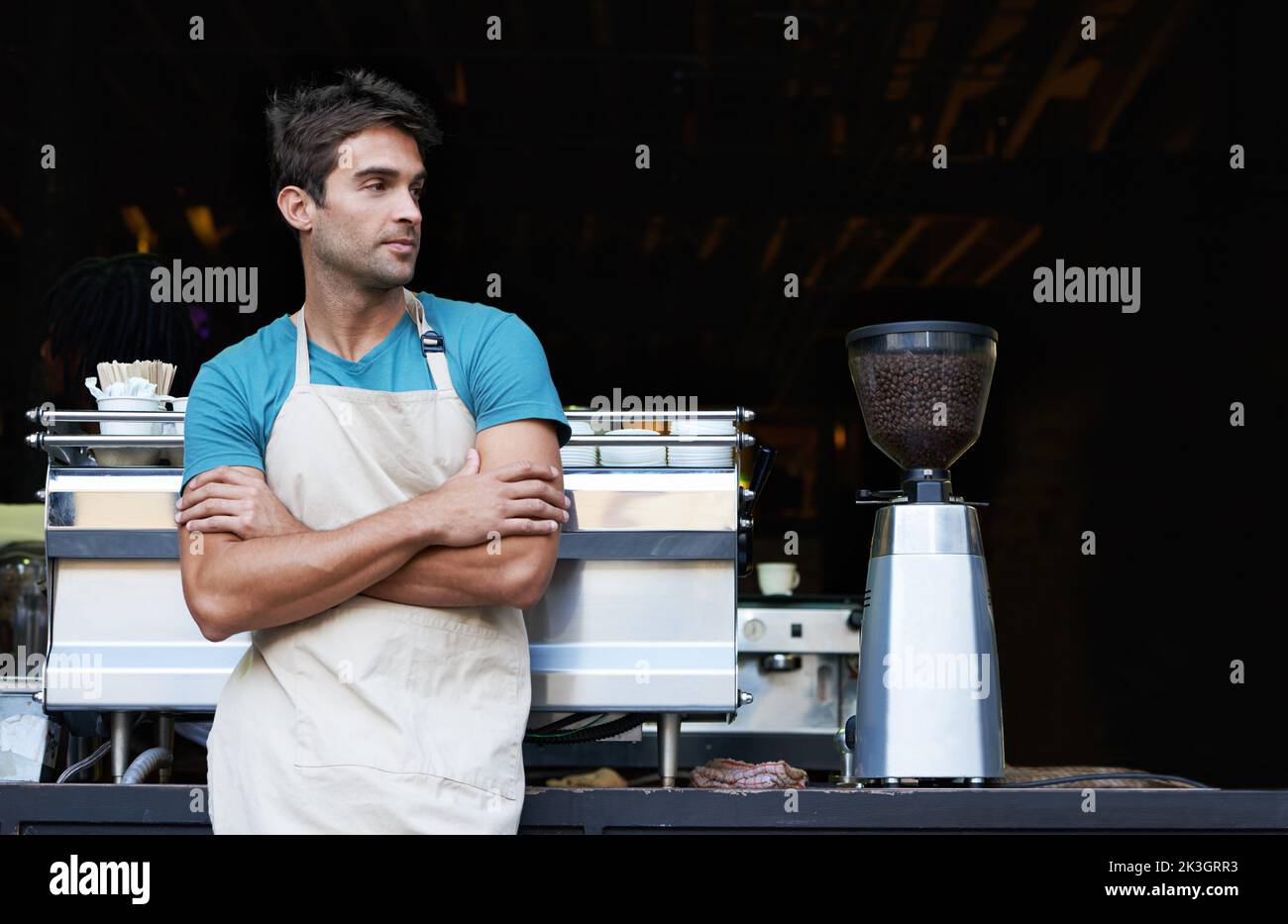He makes the best cup of coffee in town. A handsome barista standing in