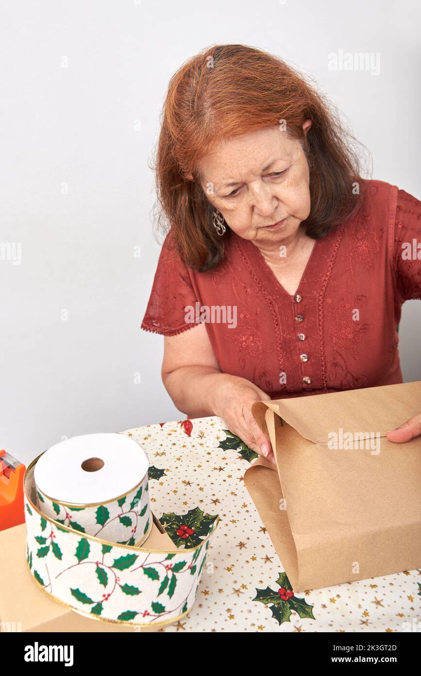 Senior woman packing hi-res stock photography and images - Alamy