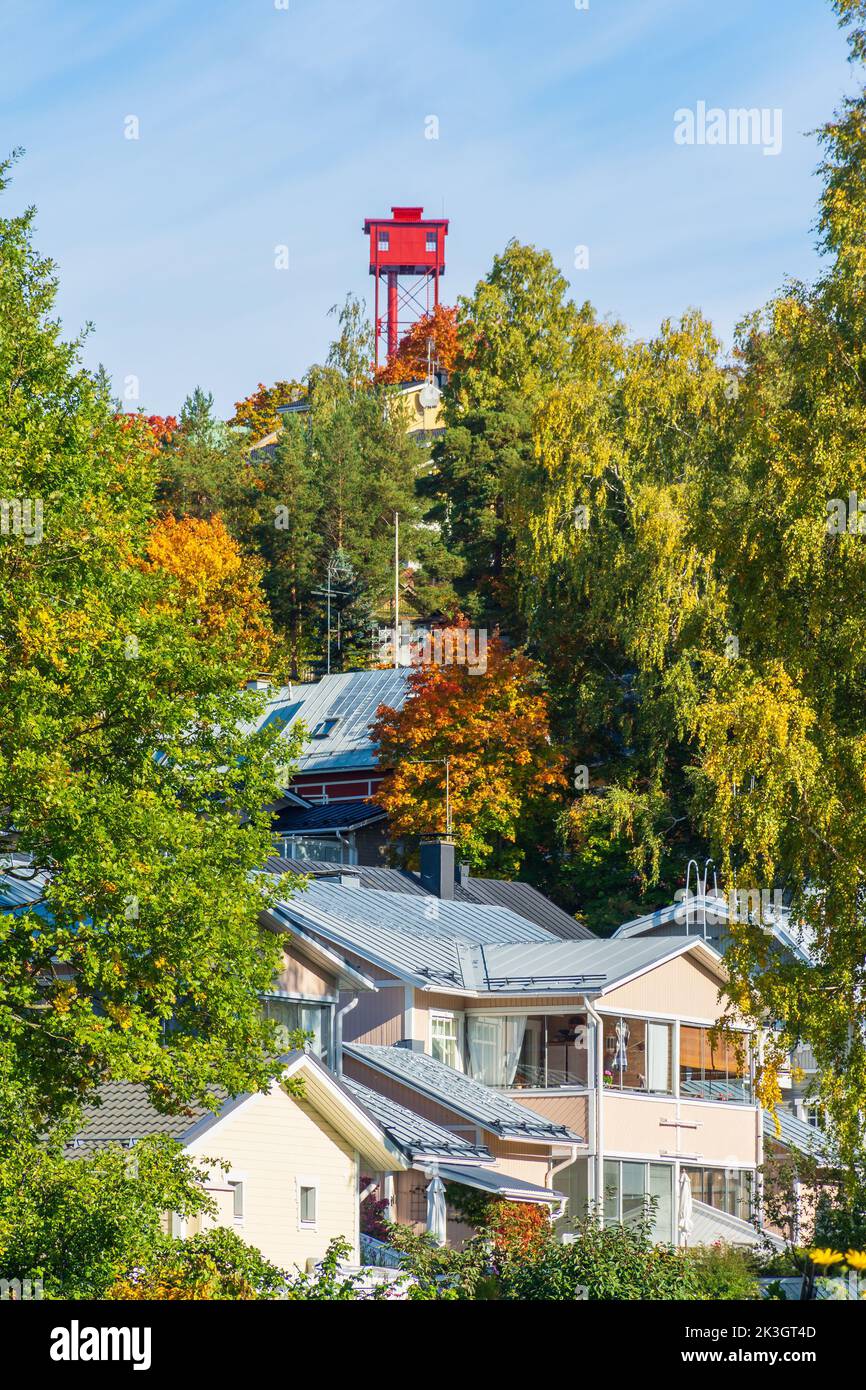 Autumnal foliage on Pispala ridge with red Pispala Shot Tower (Haulitorni) in the background in Tampere Finland Stock Photo