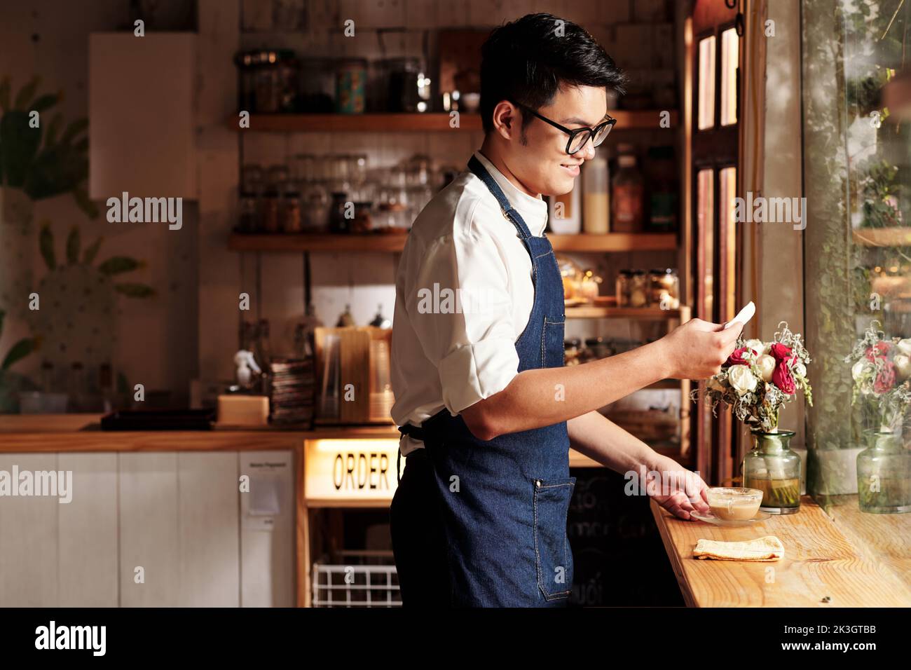 Cheerful young bartender found love note from customer Stock Photo