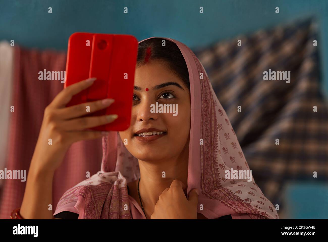 Portrait of Bihar woman looking herself on hand mirror Stock Photo