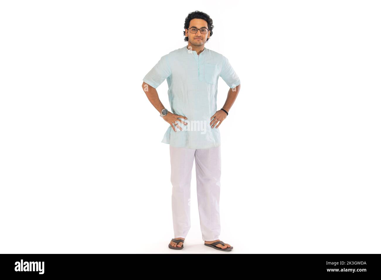 Portrait of a Bengali man standing with hands on waist against white