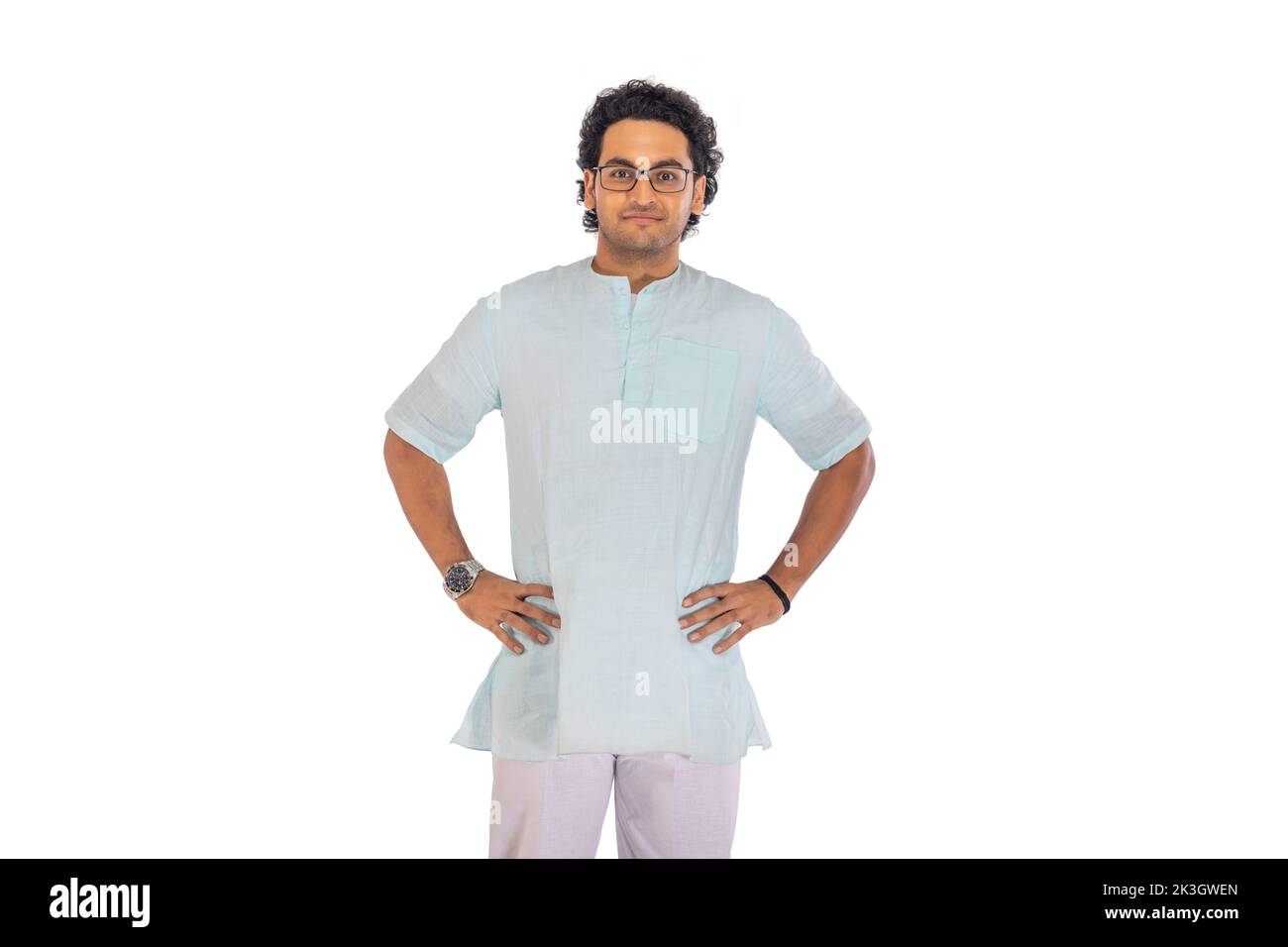 Portrait of a Bengali man standing with hands on waist against white