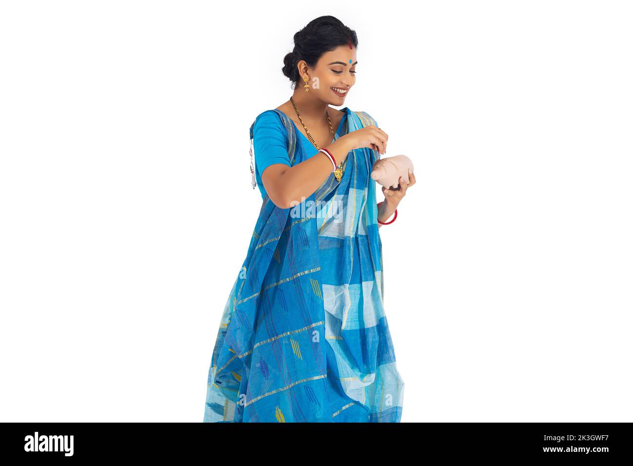 Bengali woman putting coin into the piggy bank Stock Photo Alamy