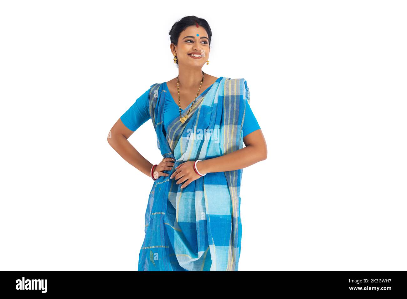 Portrait of a Bengali woman standing with hand on waist against white