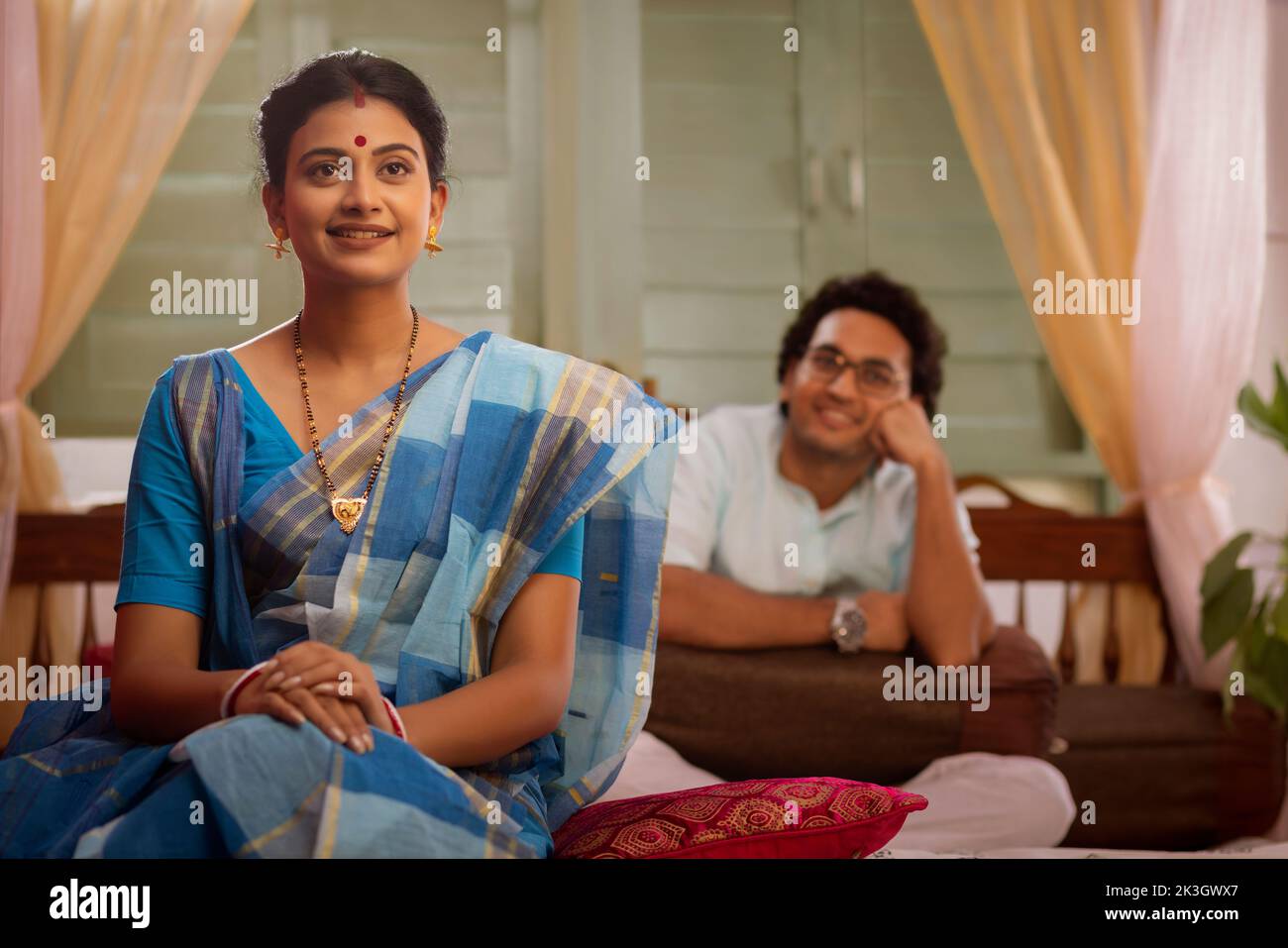 Portrait of Bengali couple sitting on bed Stock Photo Alamy