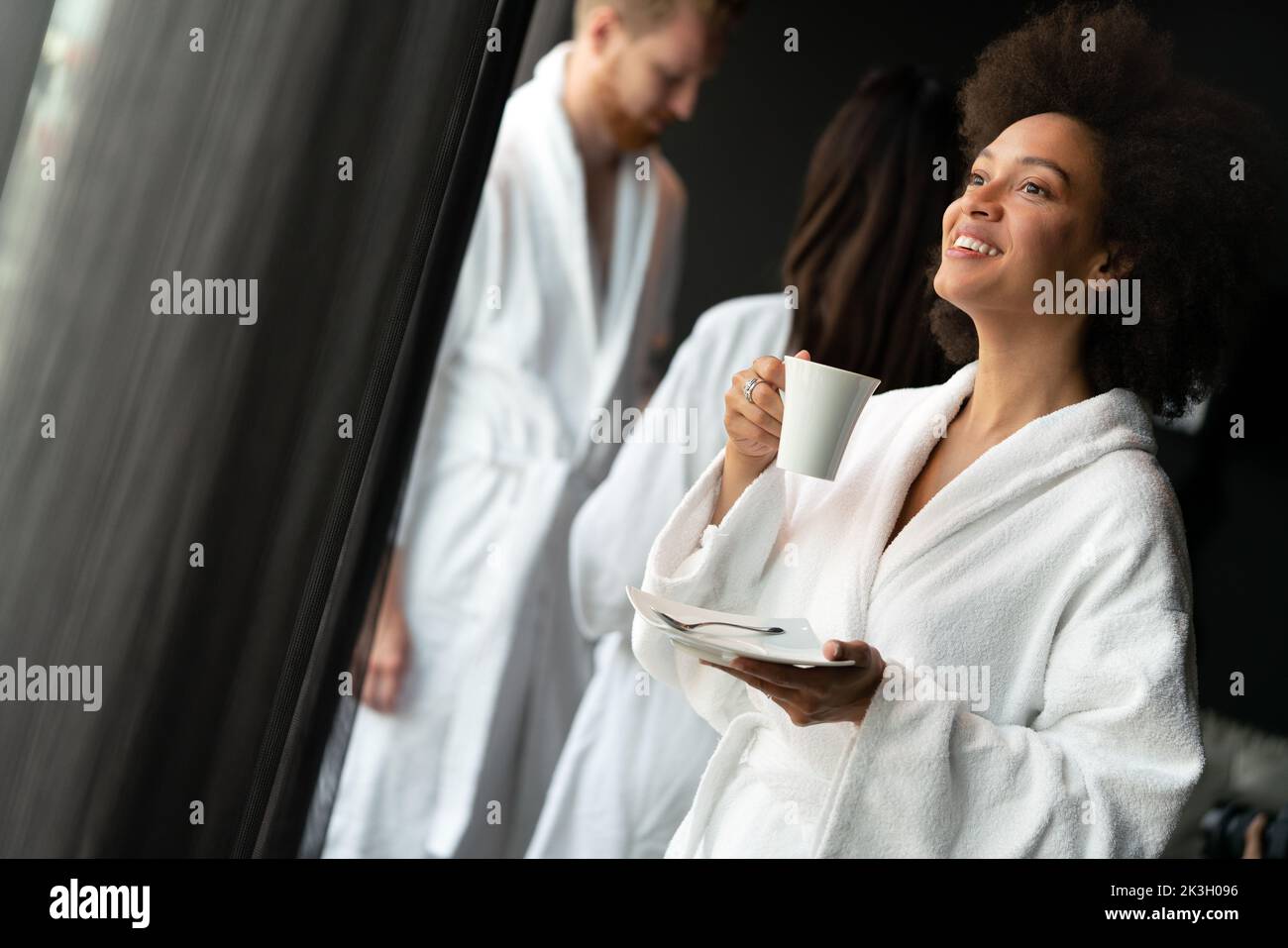 Woman in bathrobes enjoying tea during wellness weekend Stock Photo