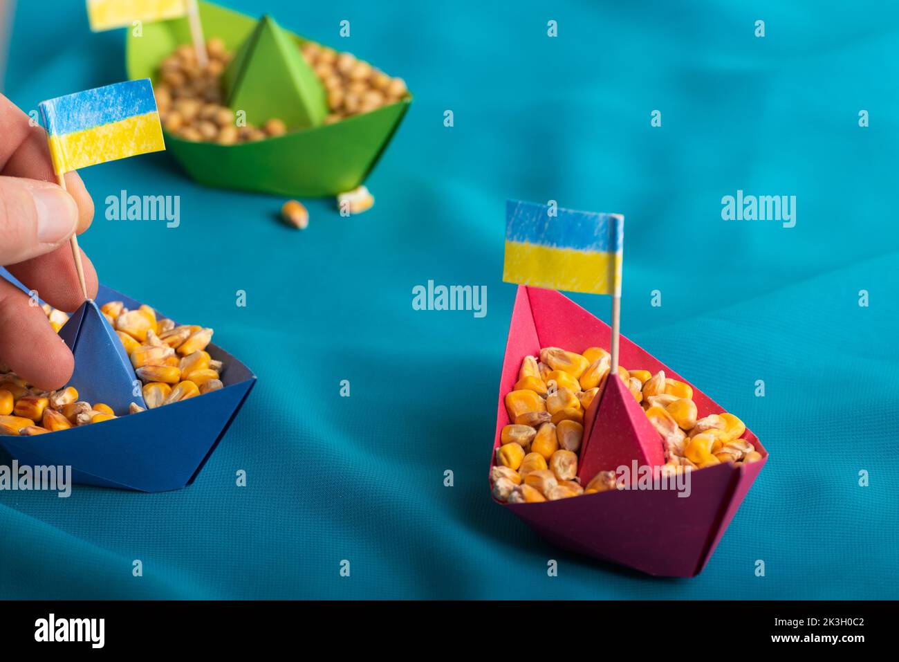 Ships with Ukrainian maize grain made of paper concept Stock Photo
