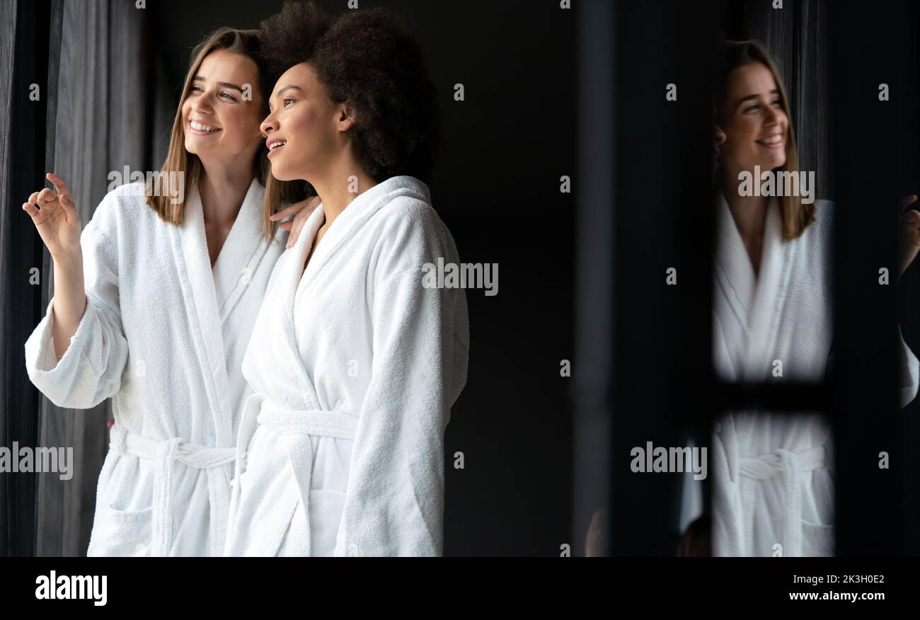 Women in bathrobes enjoying tea and wellness weekend Stock Photo
