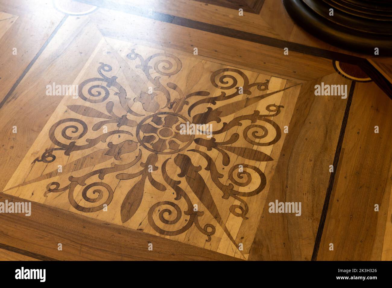 Vintage wooden parquet with floral inlay  pattern. Background photo texture Stock Photo