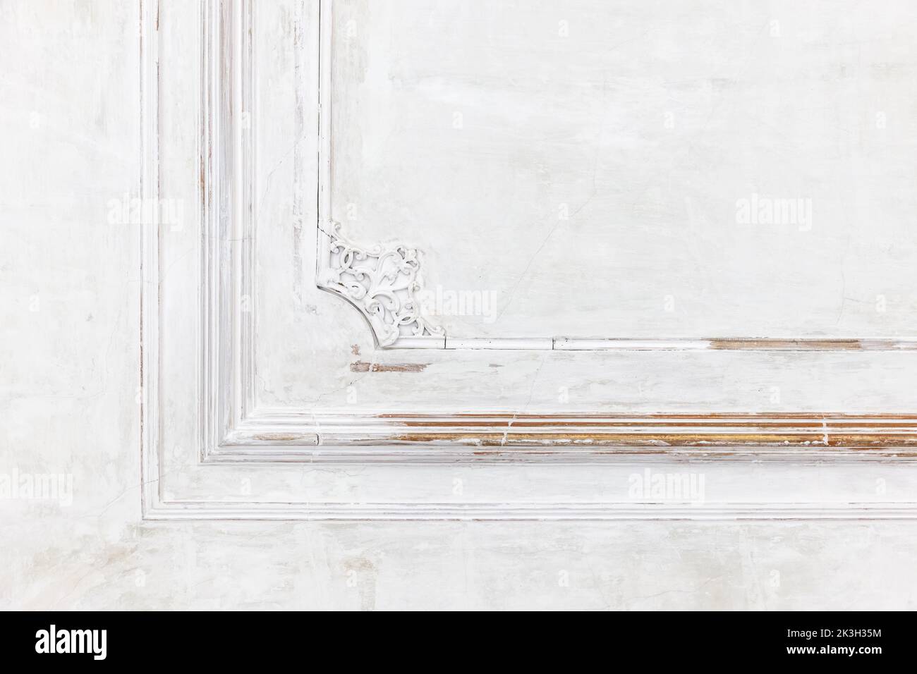 Grungy white wall with classic decoration, abstract interior fragment with a corner of a frame Stock Photo