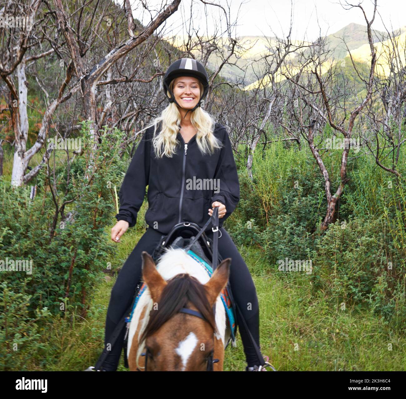 Horse riding in the outback. An attractive young woman riding a horse