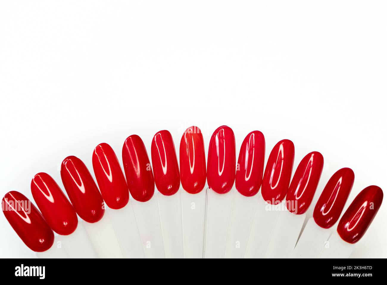 Top view red nails polish palette set for manicure on light background