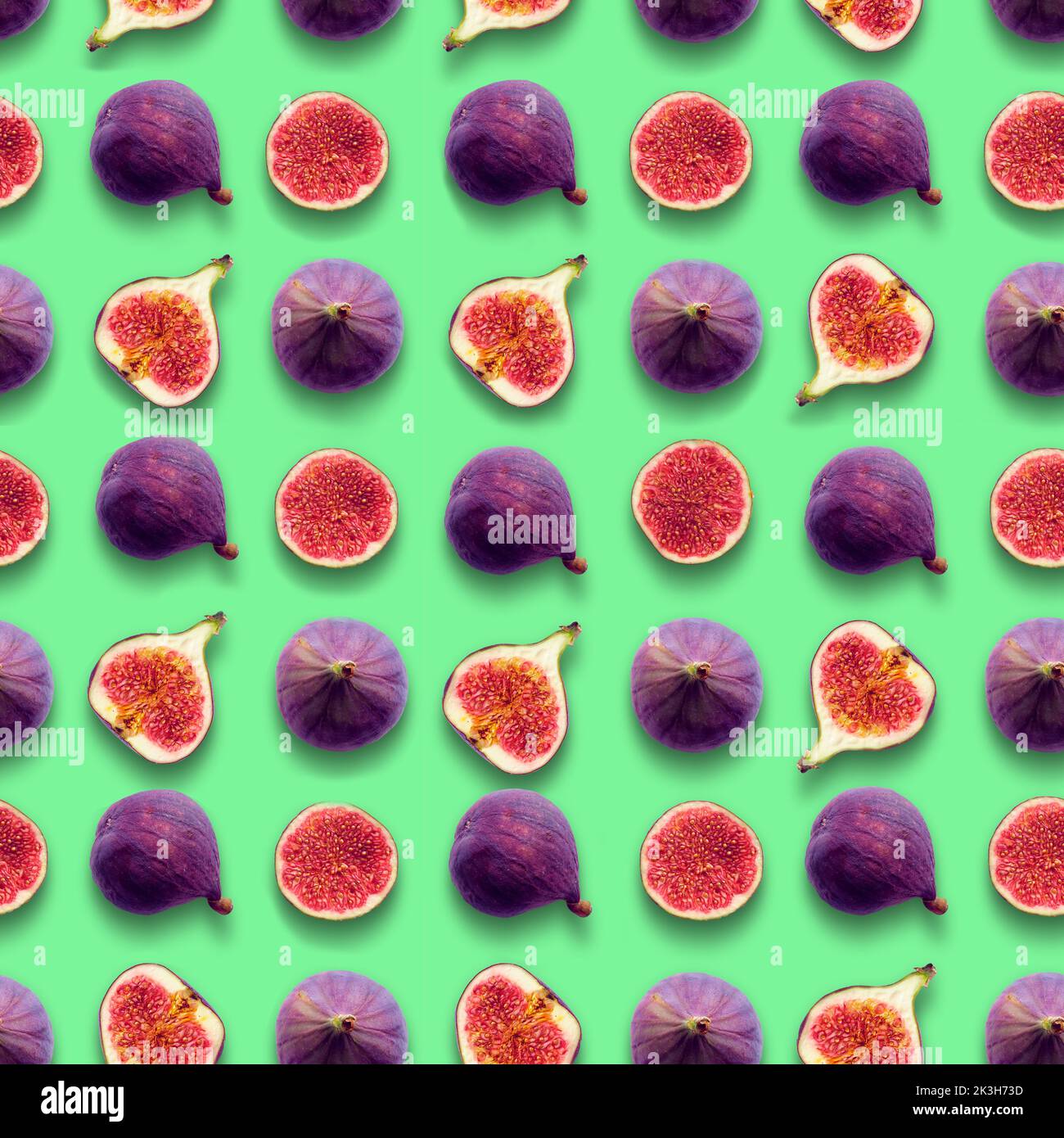 Fig fruits, whole and cut in half, seamless grid pattern on mint green color background. Stock Photo