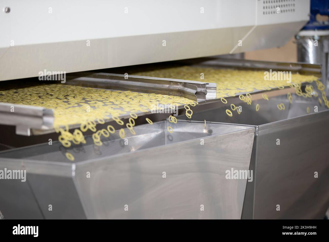 Pasta factory and stages of pasta production. The operation of drying pasta on an industrial machine. Stock Photo