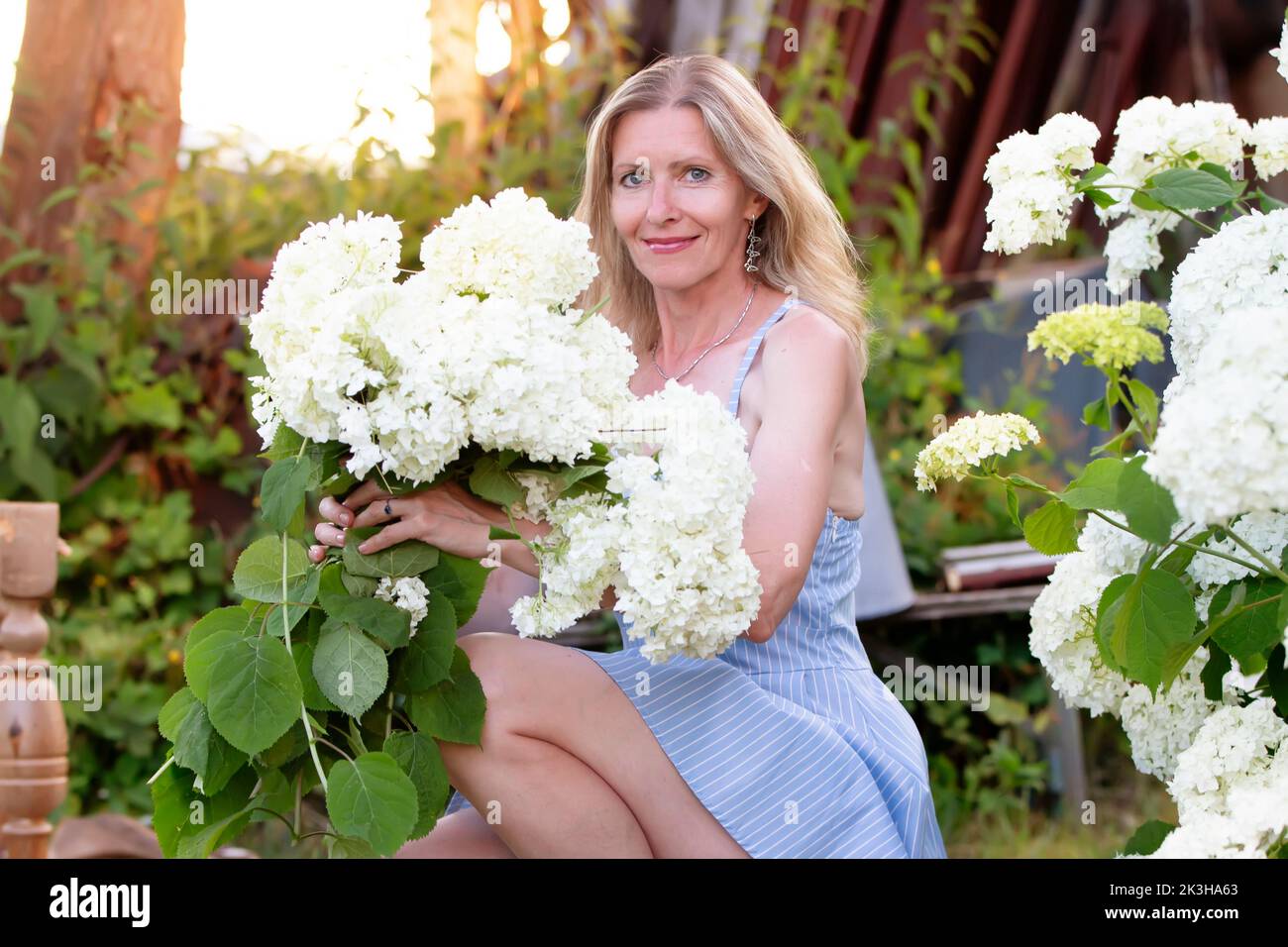 Beautiful elderly woman with a bouquet of flowers. Smiling woman in her ...