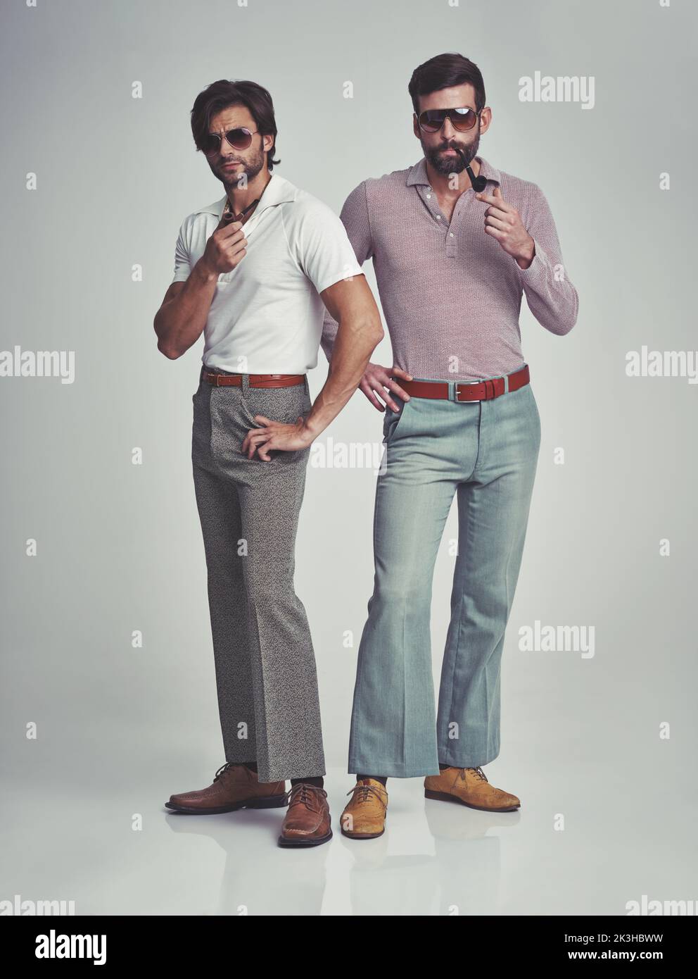 We know were groovy. Studio shot of two men standing together while ...