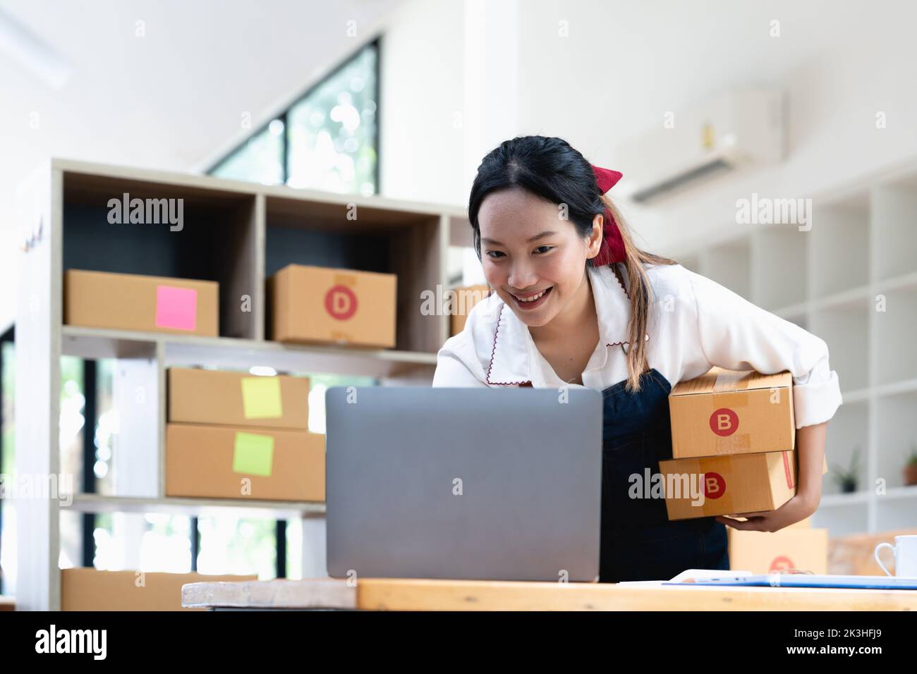 Startup small business entrepreneur SME freelance woman working with box, Young asian online market packing box delivery, SME delivery e-commerce Stock Photo