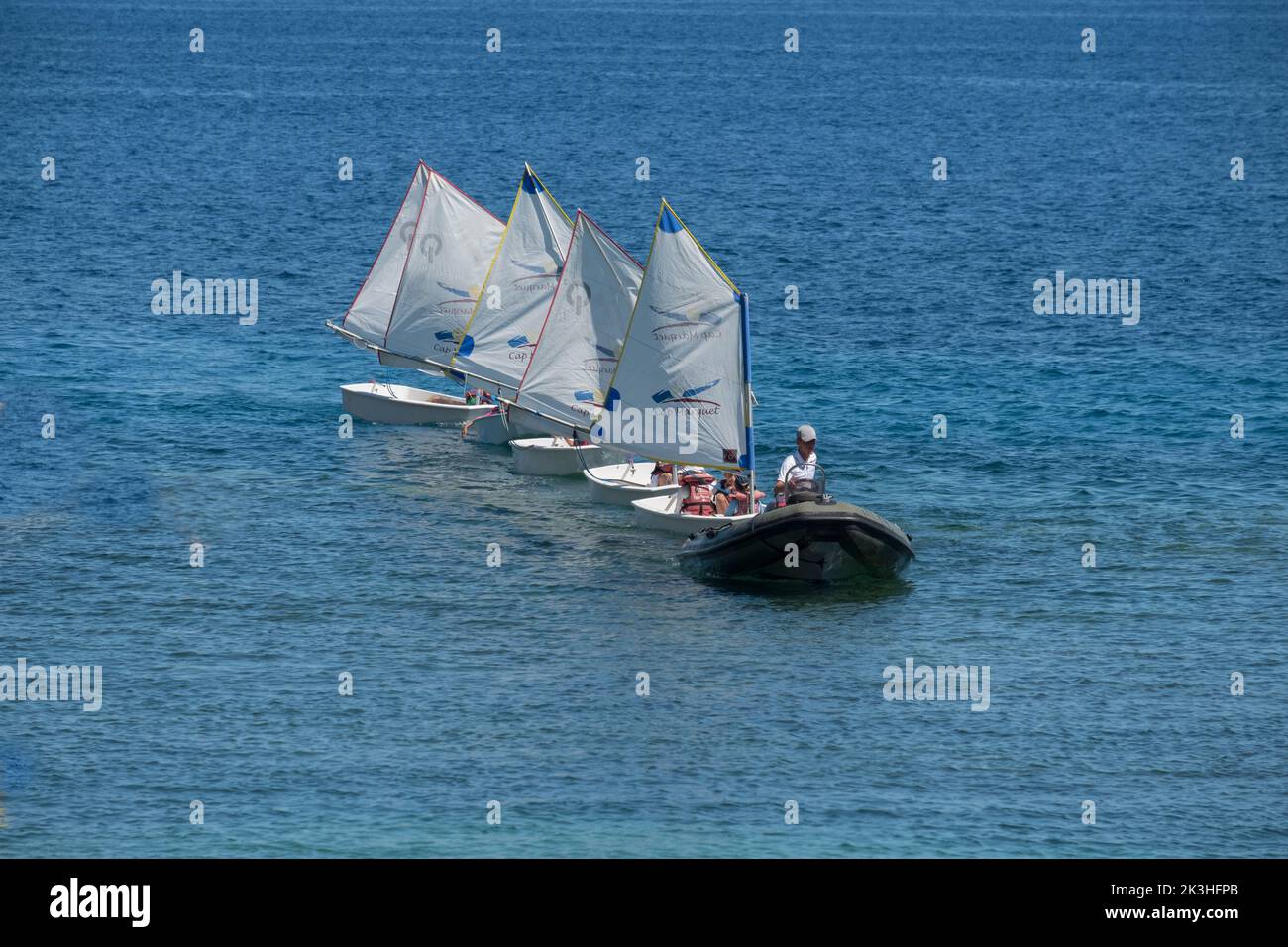 A sailing school's day is over. The students get help at home. Stock Photo