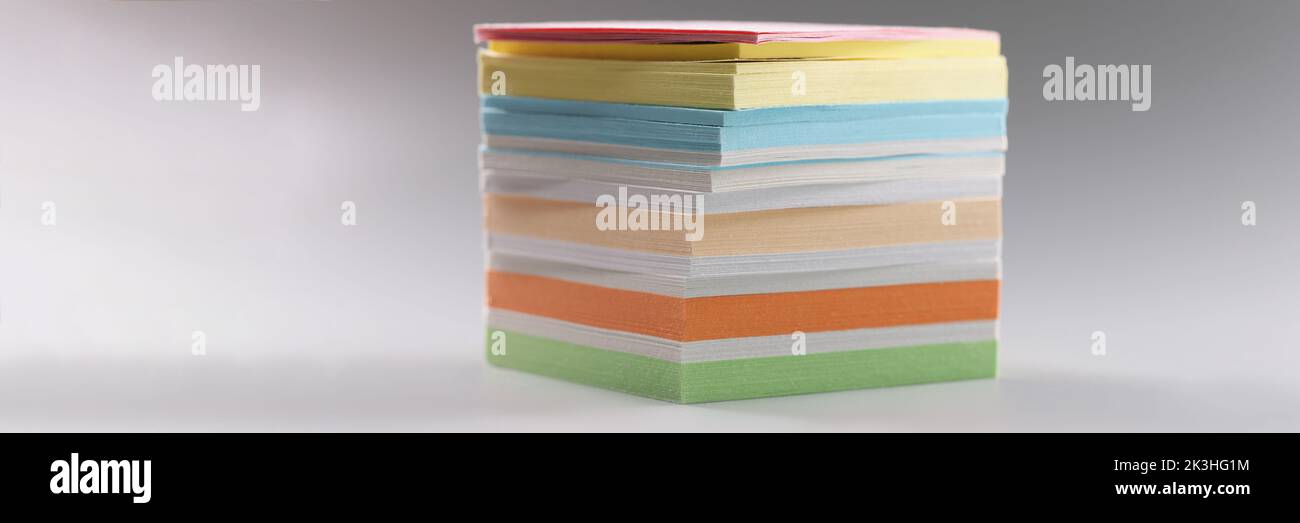 Uneven stack of sticky post it notes on grey surface, bunch of clean ...