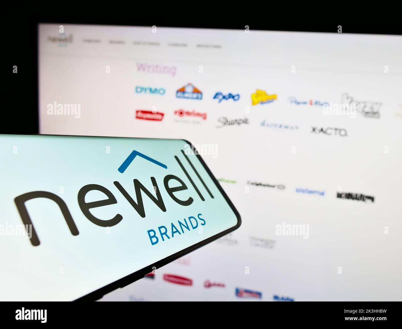 Smartphone with logo of American consumer goods company Newell Brands Inc. on screen in front of website. Focus on center-right of phone display. Stock Photo