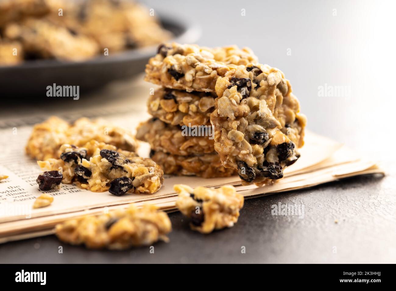 Wholegrain oat cookies. Cookies with oatmeal and raisins on the newspapers. Stock Photo