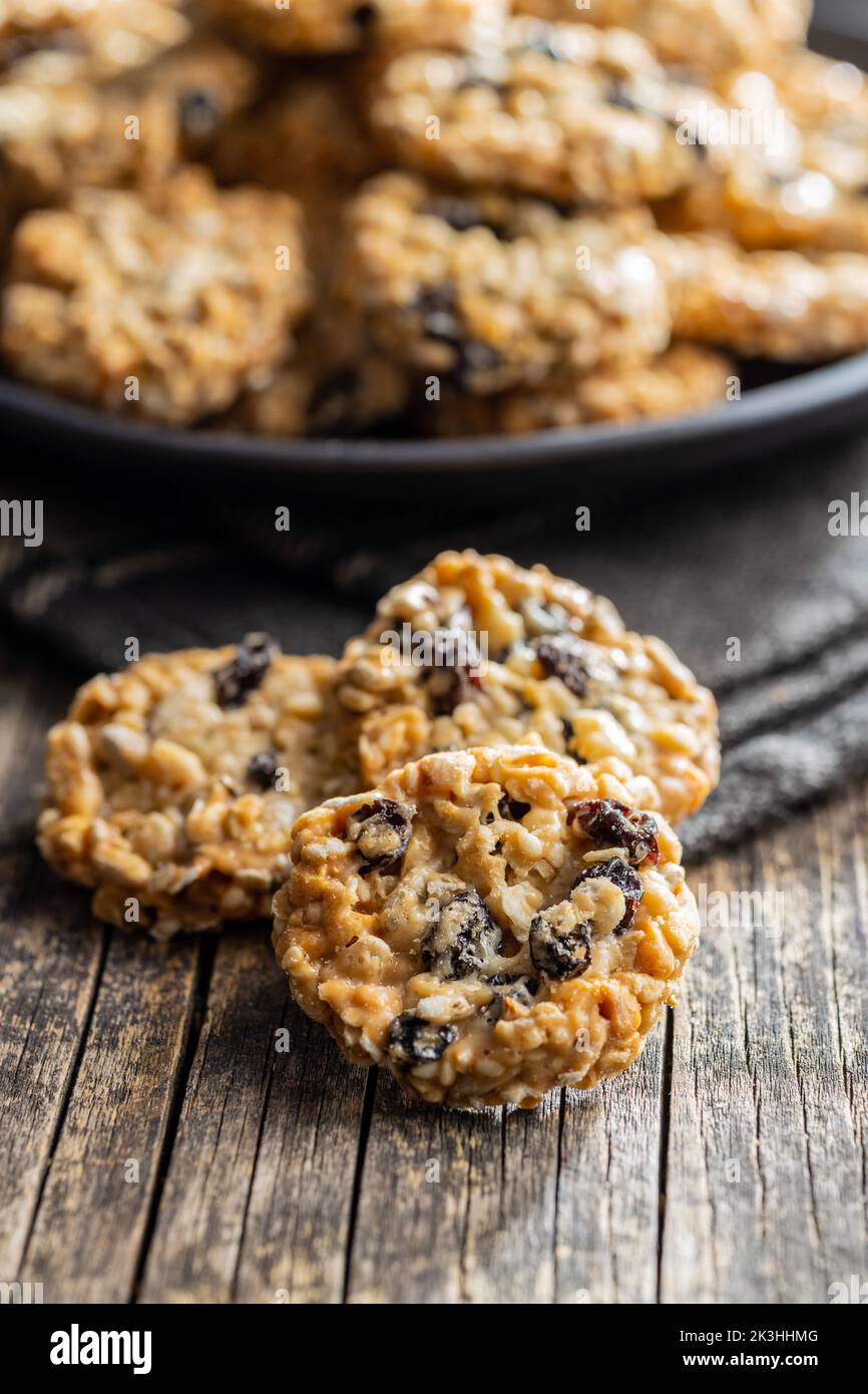 Wholegrain oat cookies. Cookies with oatmeal and raisins on the wooden table. Stock Photo